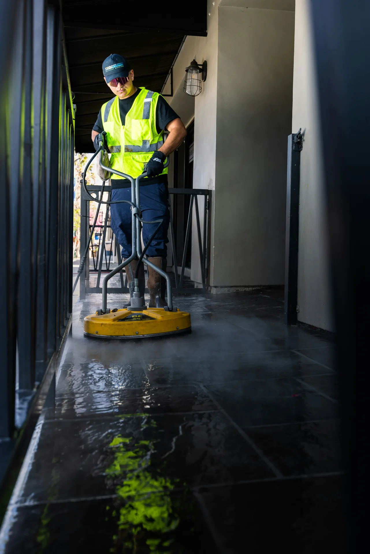 Technician Using Surface Cleaner on /oil-stain-removal/ — Kitchener Pressure Washing Kitchener